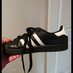 I am selling a pair of black gold and white adidas